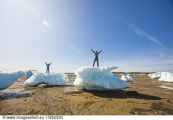 Two men standing on sea ice chunks  Iqaluit  Canada.