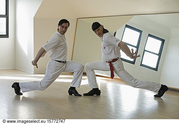 Two mid adult men dancing Flamenco