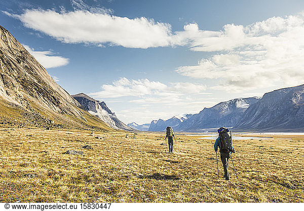 Two mountaineers cross arctic tundra in Akshayuk Pass.