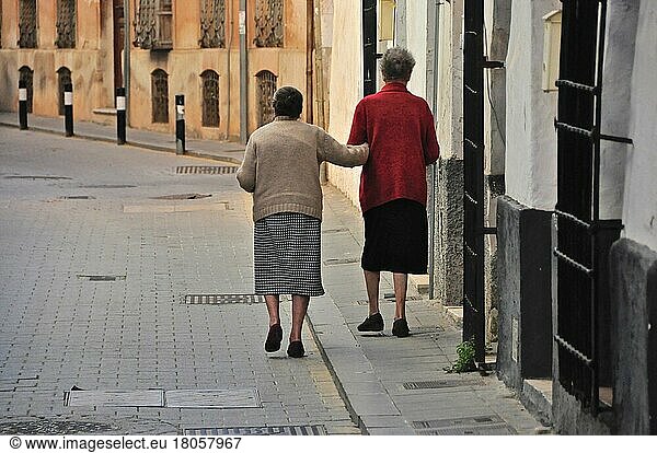 Two old woman lean on pavement while walking  Spain  Europe
