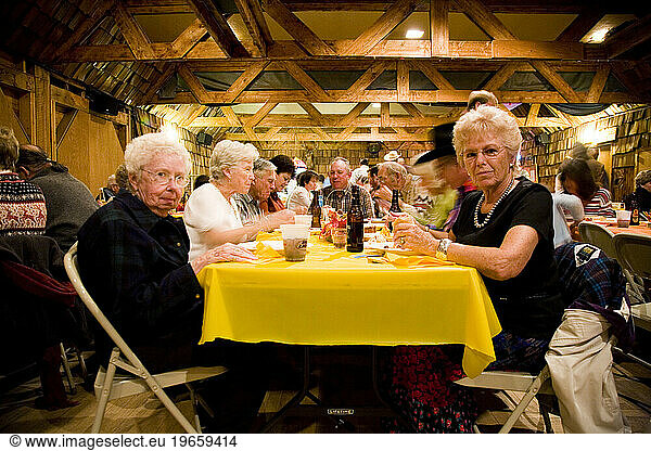 Two older women enjoy the brats at the annual Octoberfest celebration in Dubois  WY.