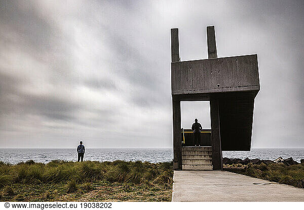 Two people at concrete watchtower by the ocean  Lagoa  Azores