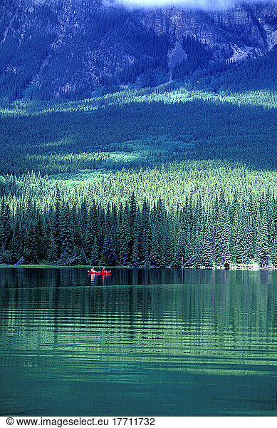 Two People Canoeing Across Pyramid Lake  Jasper  Alberta  Canada.