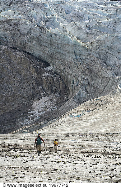 Two people hiking on a glacier in Alaska  United States.