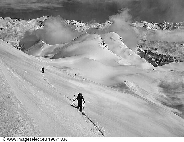Two people ski touring in the French Alps.