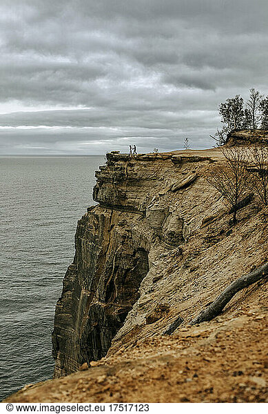 Two people walking cliff edge  Pictured Rocks Lakeshore  Michigan