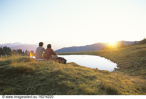 Two people watching sunset