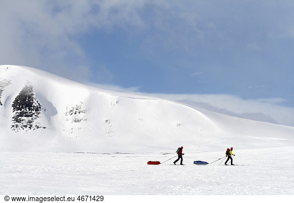 Two persons are crosscountry skiing on mountain