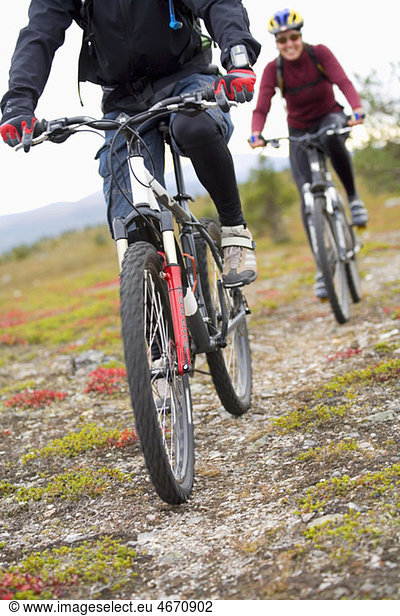 Two persons biking on a trail