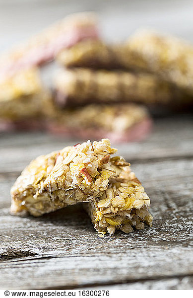 Two pieces of granola bar on wooden table  close-up