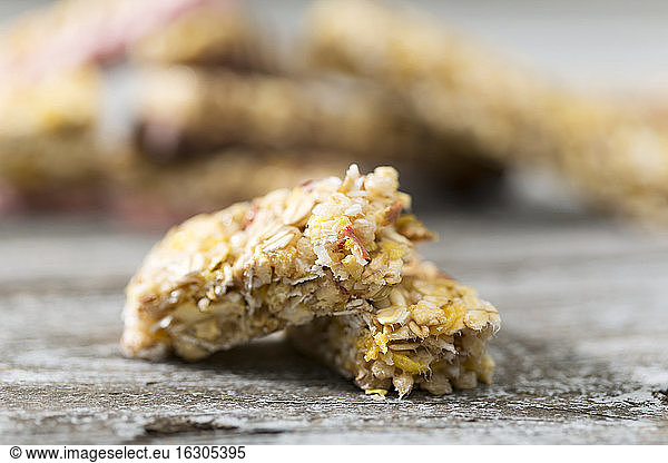 Two pieces of granola bar on wooden table  close-up