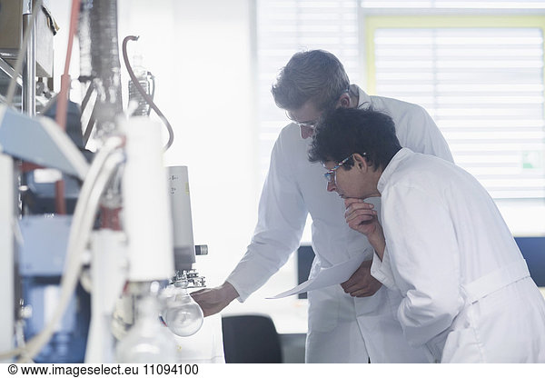 Two scientist working in a pharmacy laboratory