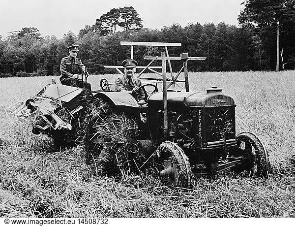 Two Soldiers  Released for Temporary Emergency Farm Work  Operating Tractor and Harvester to cut Ten-Acre Field of Oats during Crop Season  which helped Ease Farm Labor Shortage during World War II  Northern Ireland  UK  U.S. Office of War Information  April 1943