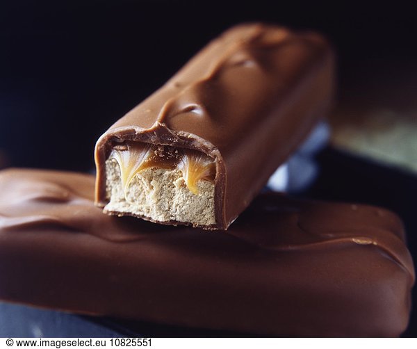Two stacked milk chocolate bars with caramel and nougat filling