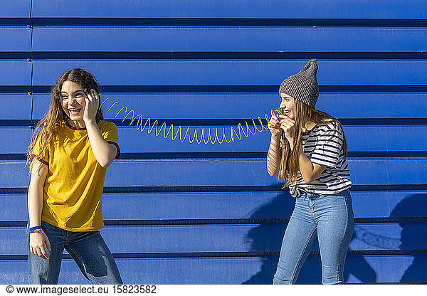 Two teenage girls having fun outdoors
