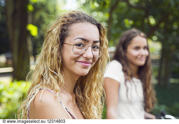 Two teenage girls (14-15) in park
