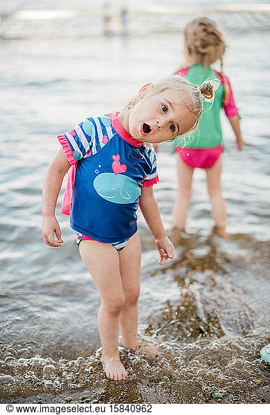 Two toddler girls cooling off at the lake.