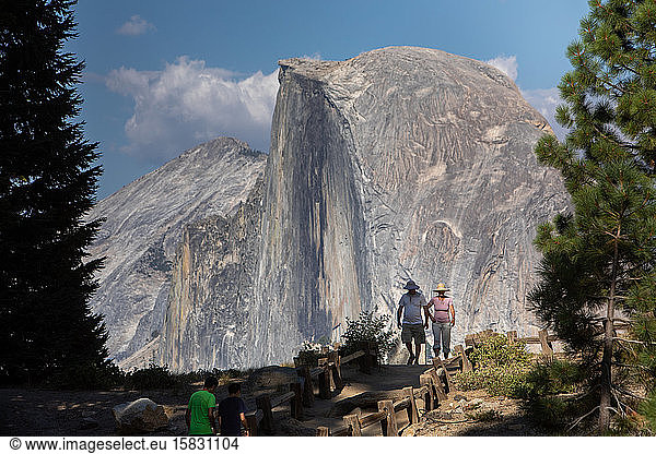 Two tourists  Half Dome  Yosemite  view from Glacier Point.