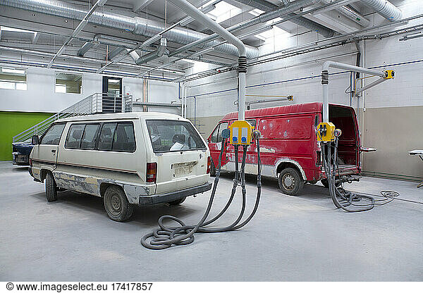 Two vans in a large repair workshop for repair and respraying
