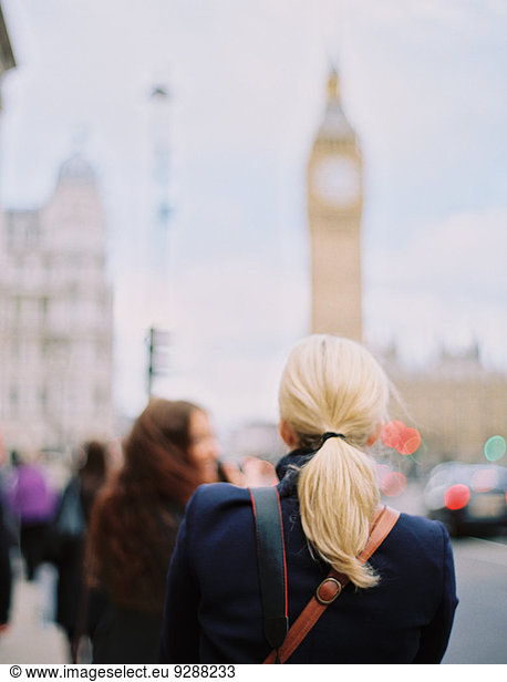 Two women in London on the street near Big Ben  The Elizabeth Tower in Westminster  in London.