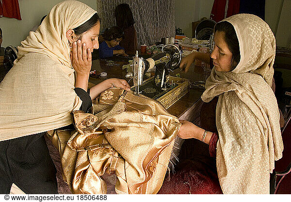 Two women sew curtains in a Kabul workshop.