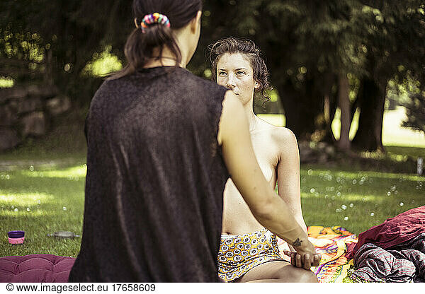 two women share massage and healing in natural park land france