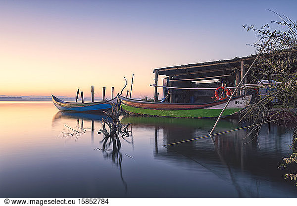 two wooden boats at sunset