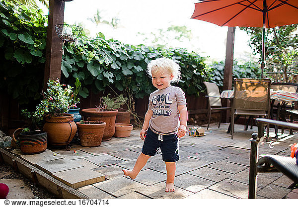 Two Year Old Boy Smiling & Playing in Front Yard