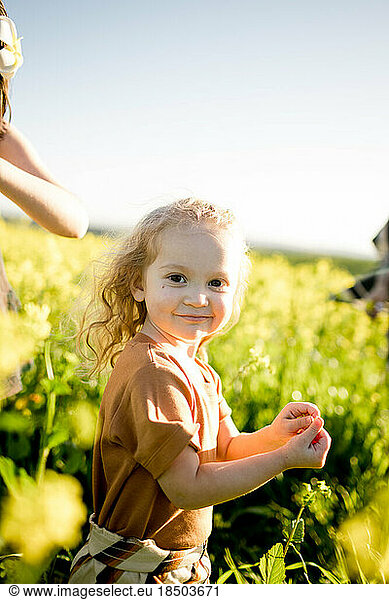 Two Year Old Girl Standing in Flower Field in San Diego