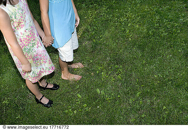 Two Young Girls Holding Hands Outside