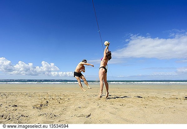 Two young people playing volleyball on the Atlantic beach  Finistere  Brittany  France  Europe