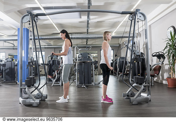 Two young women fitness studio sport practising