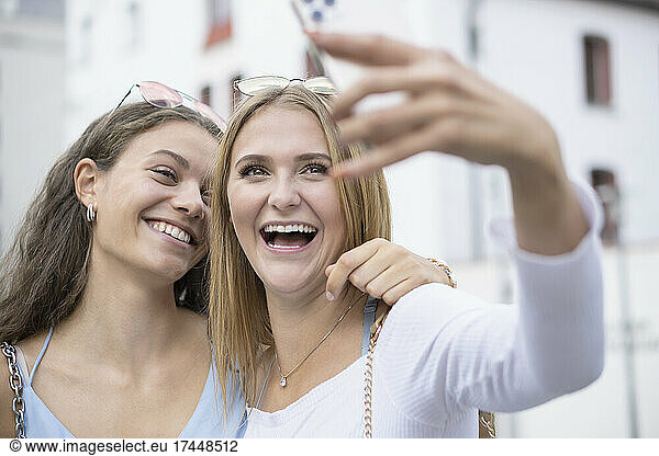 two young women making selfy with mobilephone in surroundings