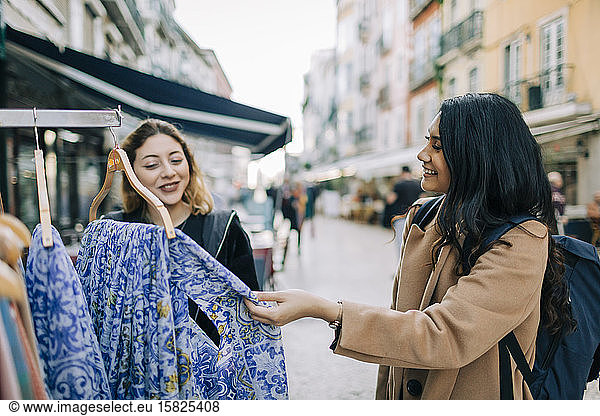 Two young women shopping together in the city  Lisbon  Portugal