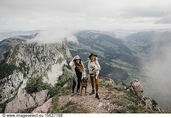 Two young women with dogs on viewpoint  Grosser Mythen  Switzerland