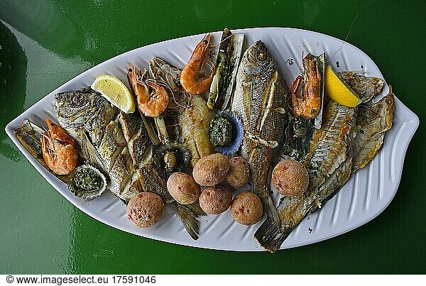 Typical fish platter with various grilled fish  mussels razor clams  prawns  Canarian potatoes  side dishes  Lanzarote  Canary Islands  Spain  Europe