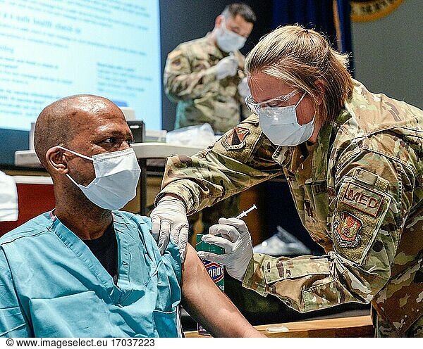 U. S. Air Force Maj. Kito Brooks  88th Medical Group  podiatrist  receives the COVID-19 vaccine from Capt. Erica Eyer  88MDG  flight commander  Aerospace Operational Medicine Clinic at Wright-Patterson Air Force Base  Ohio on Jan. 4  2021.