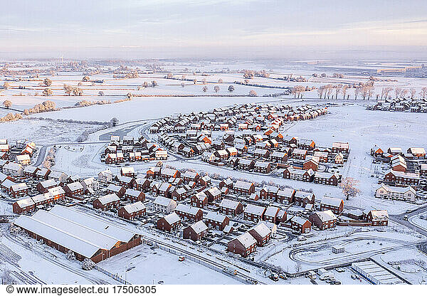 UK  England  Lichfield  Aerial view of snow-covered suburb at dusk