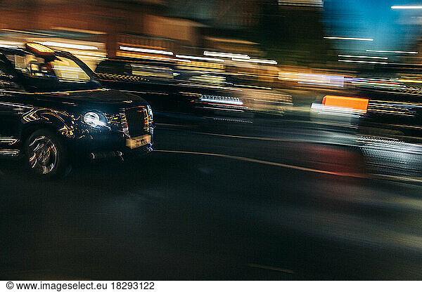 UK  England  London  Blurred motion of driving taxi and surrounding traffic at night