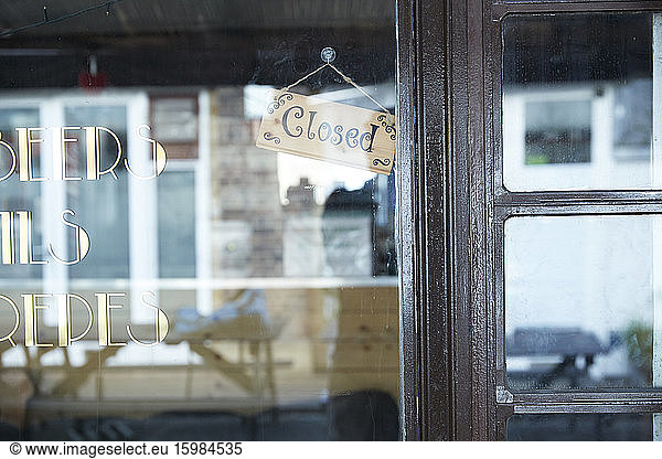 UK  England  London  Closed sign hanging behind shiny window