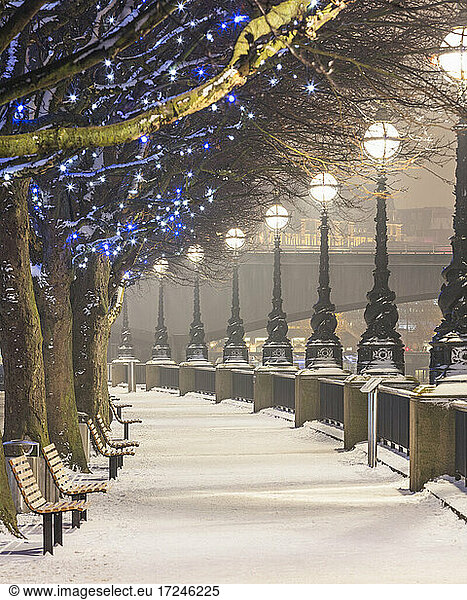 UK  England  London  Rows of street lights illuminating empty South Bank promenade in winter