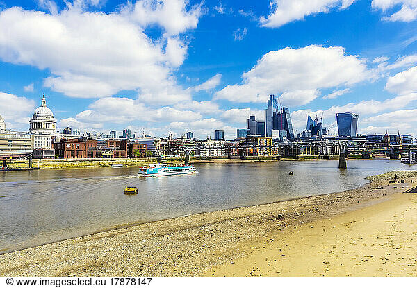 UK  England  London  Sandy bank of river Thames with city skyline in background