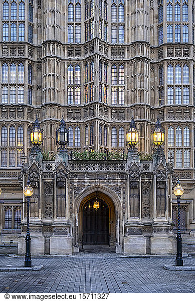 UK  England  London  Street lights glowing in front of Palace of Westminster entrance at dusk