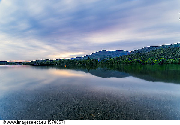 UK  England  Long exposure of clouds over Coniston Water lake at dusk