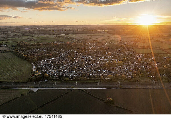 UK  England  Whittington  Aerial view of countryside town at sunset