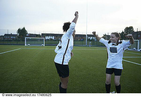 UK  Female soccer team members (10-11  12-13) cheering in field