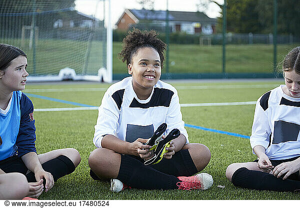 UK  Female soccer team (10-11  12-13) sitting in field during training