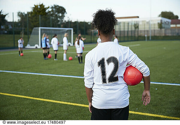 UK  Girls soccer team (10-11  12-13) having training in field