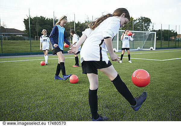 UK  Girls soccer team (10-11  12-13) having training in field
