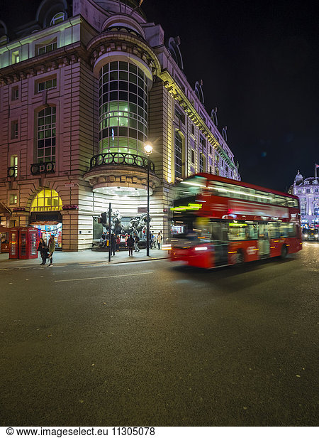 UK  London  Piccadilly Circus  driving double-decker bus at night